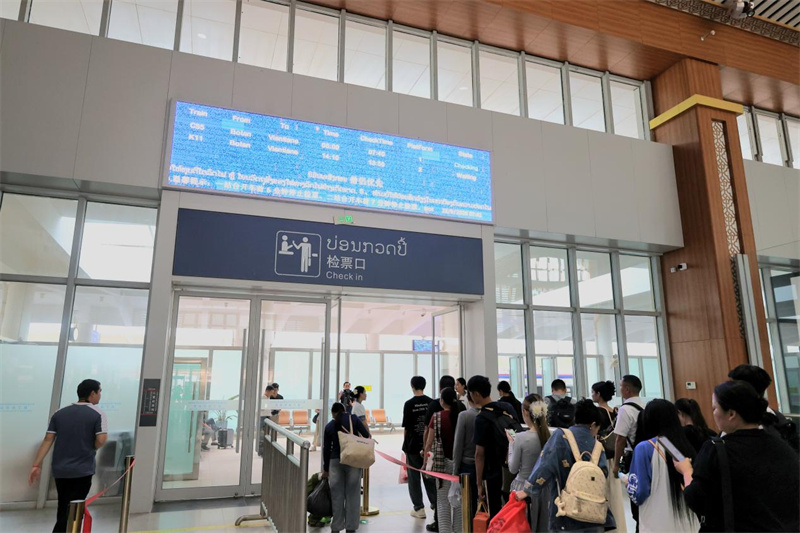 乘客在老挝磨丁检票口有序排队等候上车。老中铁路有限公司供图